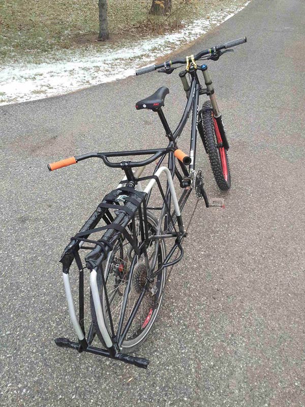 Rear, right side view of a black Surly Big Dummy bike, parked on a paved street