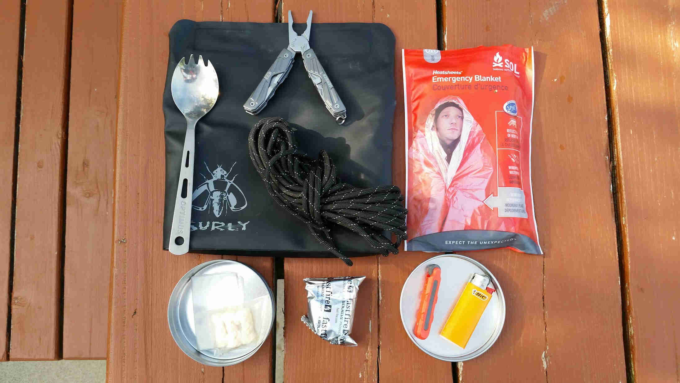 Downward view of fire starting supplies, on top of a wood picnic table