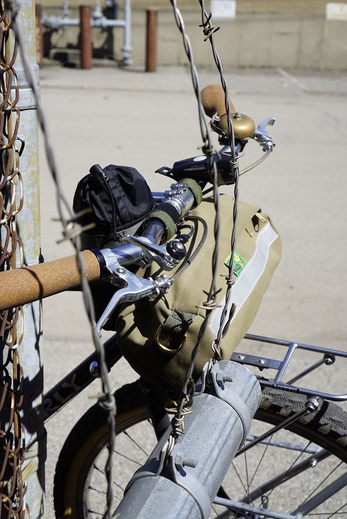 Right side view of Surly Pack Rat bike handle bars with storage bag with barbed wiring wrapped around them