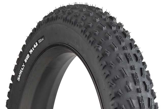 Surly Bud 26 x 4.8 inch fat bike tire mounted on rim showing tread and sidewall with white hot patch on white background