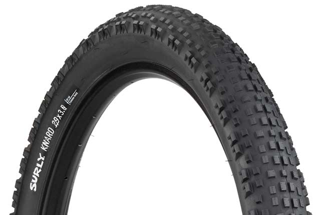 Surly Knard 29 x 3 inch tire mounted on rime showing tread and sidewall with hot patch on white background