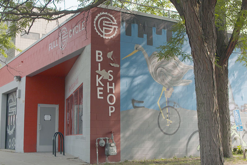 Full Cycle Bike Shop outside view with mural painted on wall