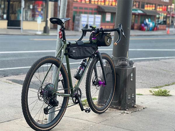 Midnight Special parked on urban sidewalk near bagel shop