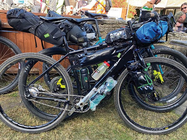 Surly Ogre full loaded, parked in front of two other loaded bikes outside pub