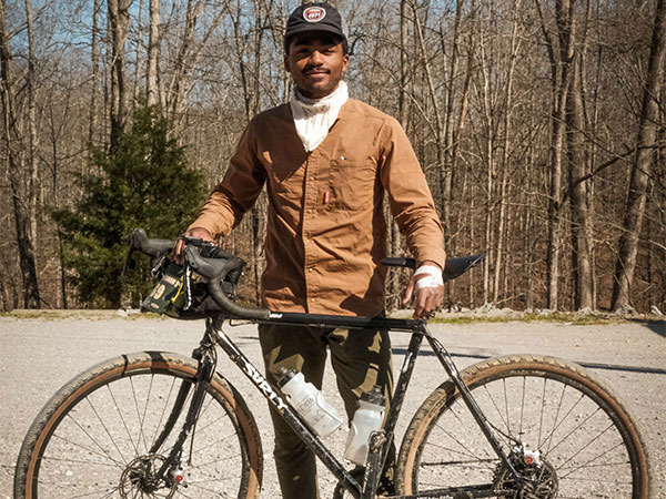 Caz's standing with his Surly Straggler on gravel road