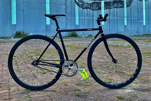 Black Surly Steamroller with flat bar outside in front of building