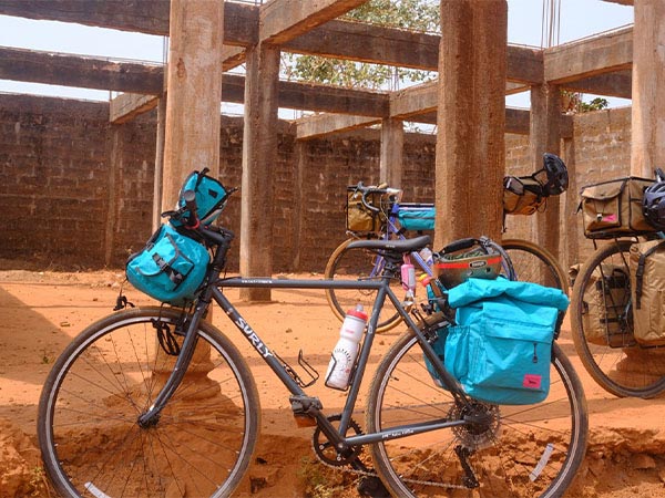 Loaded bikes parked outside next to building foundation