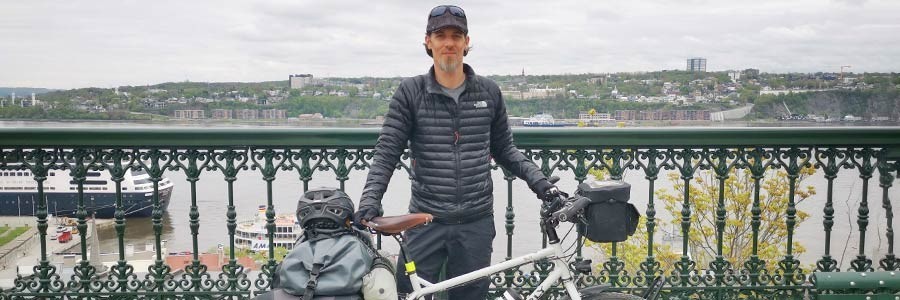 Yann standing with loaded Surly Troll bike in front of river overlook