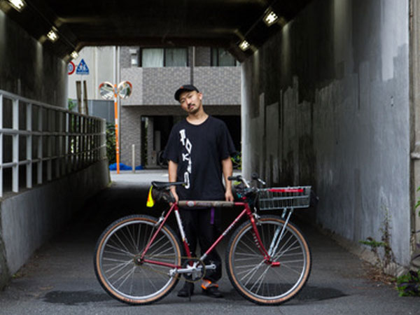 Kaneyan standing behind bike in tunnel