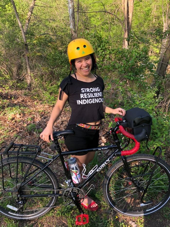 Andrea smiling at the camera on her bike