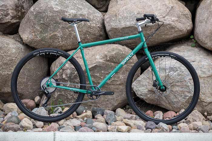 Surly bike leaning on boulders while wheels are on rocks