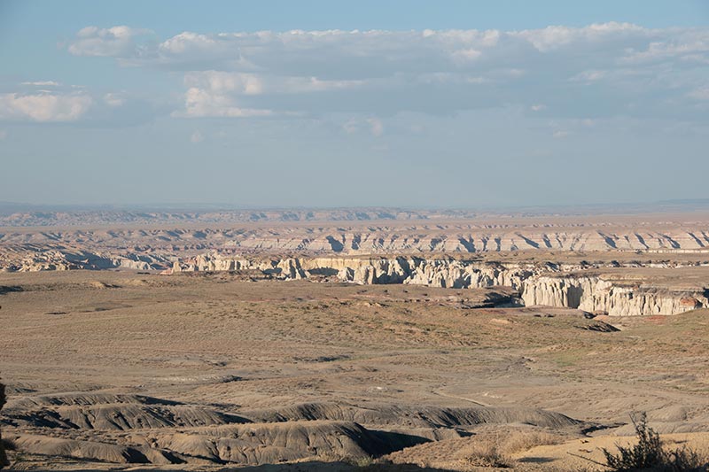 View of desert canyons and hills from overlook on sunny day