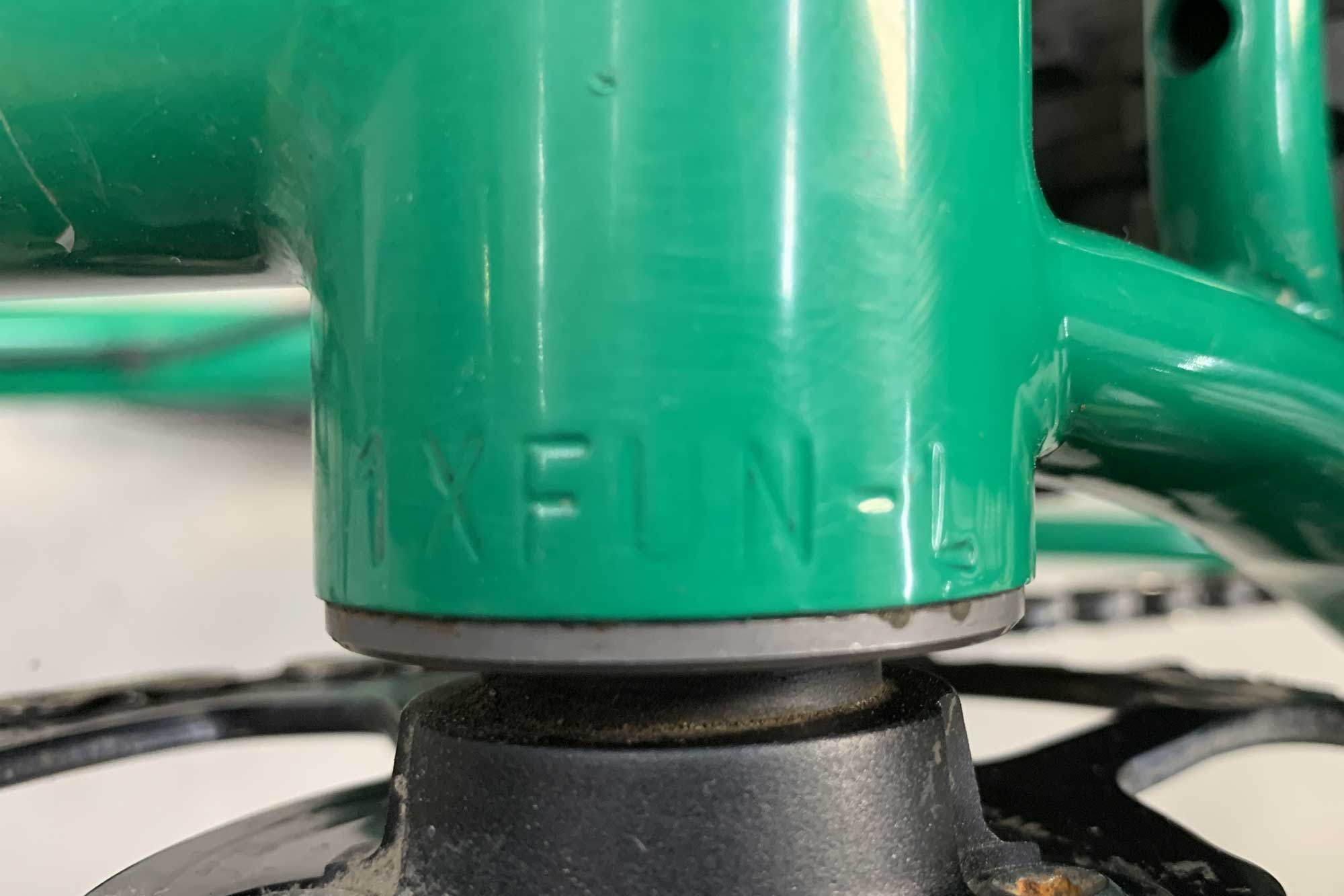 Close up view of the serial number on the bottom bracket a green Surly bike frame