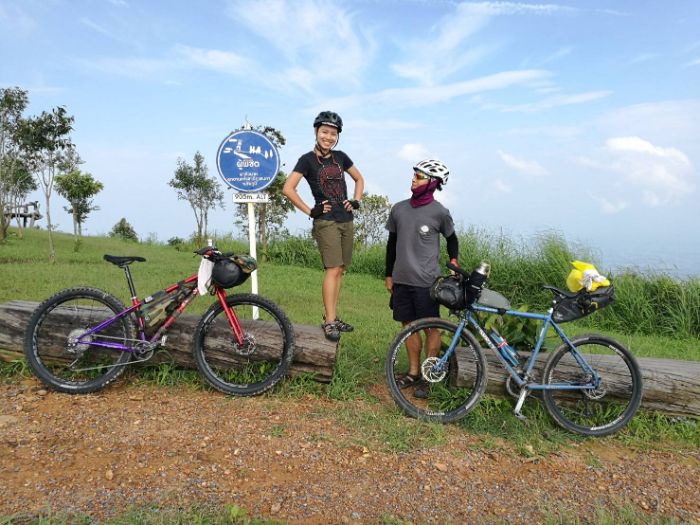 Immu standing proudly on a guard rail near her bike