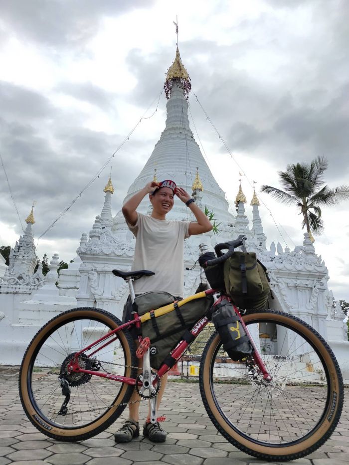 Immu standing with her bike smiling