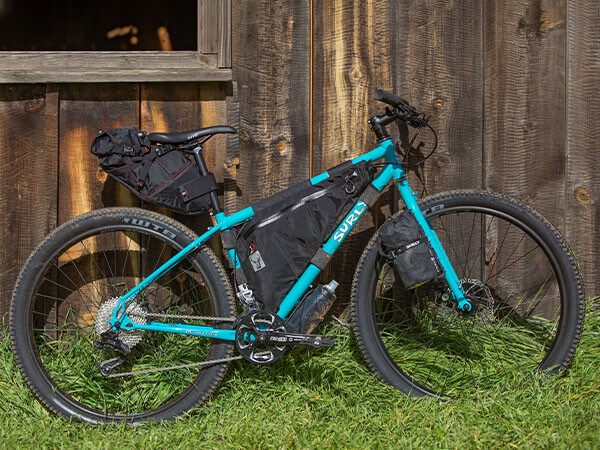 Surly Bridge Club bike set-up for bikepacking, with seat pack, frame pack, and bag attached to fork