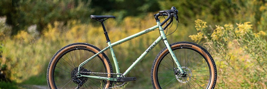 Surly Grappler bike side view outside on gravel road